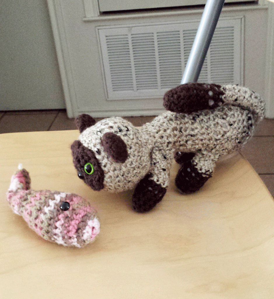 Picture of a crocheted stuffed animals as a fish and cat