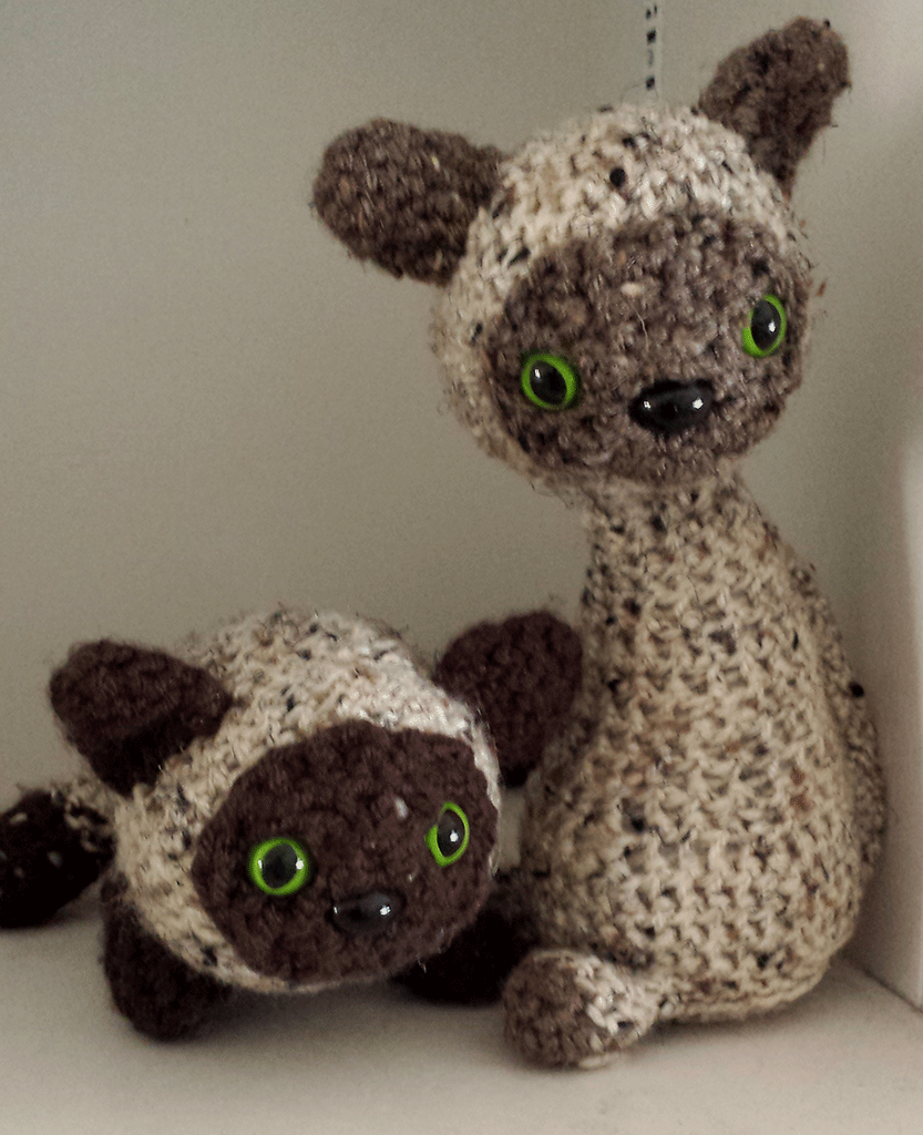 Picture of a crocheted stuffed animals as cats
